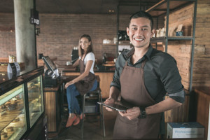 cafe owner using tablet pc