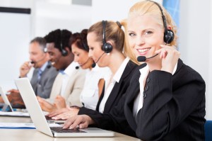 21668243 - happy co-workers wearing headsets working in call center