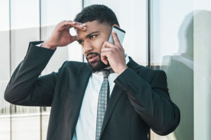 Concerned businessman speaking on phone